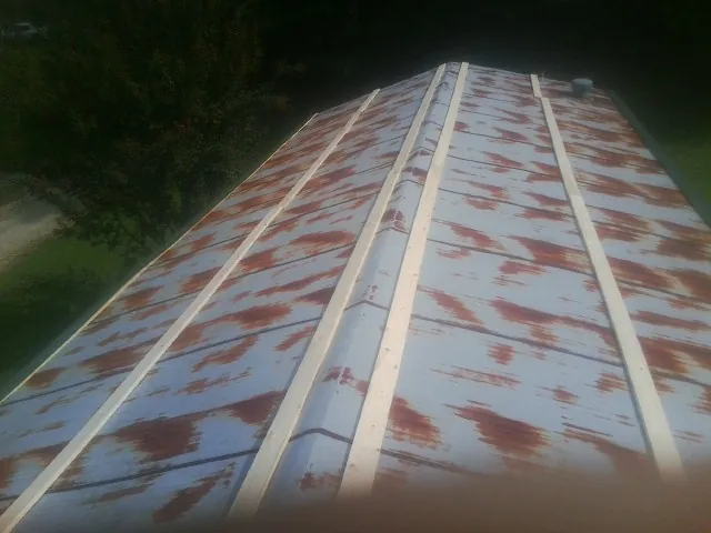 Rusted metal roof panels with new wood purlins before replacement — Storm Damage Roof Repair in Longs by Roofing Brothers